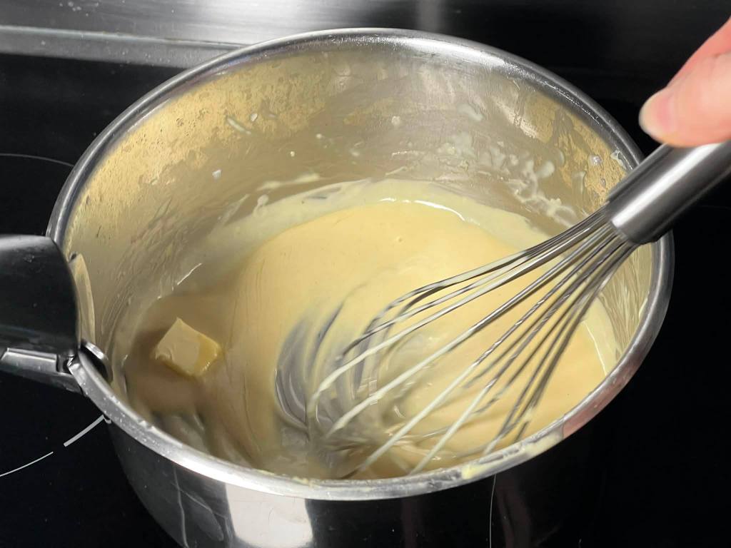 Garstyčių padažas, į padažą puode įmaišomas šaltas sviestas